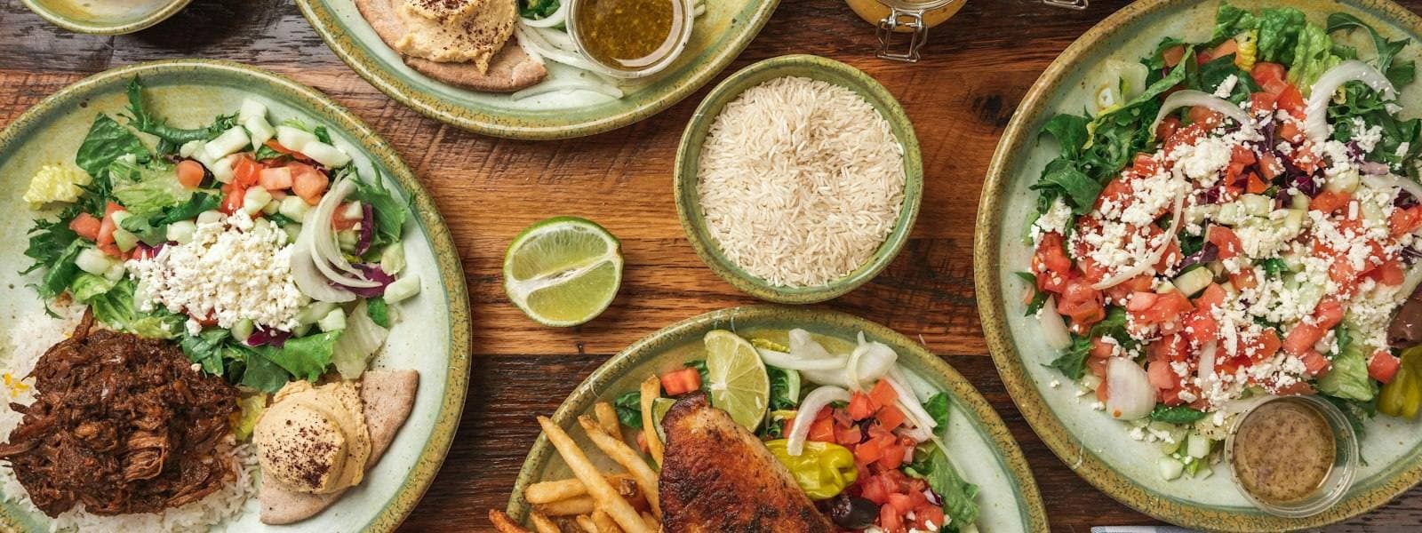 Plates of shawarma, salads and rice